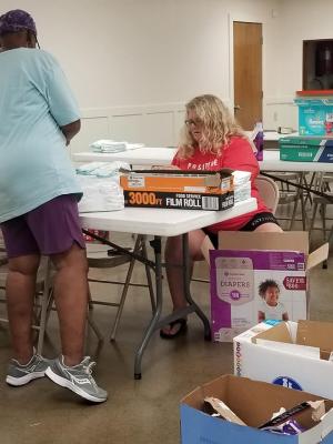 Volunteers help to sort and pack the donations to help get them out into the community. 